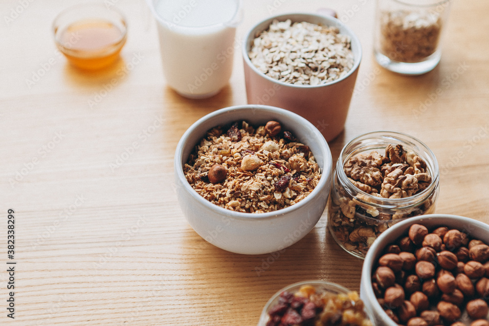 a delicious and crunchy oatmeal granola with honey, nuts, dried fruits and grains. Dynamic healthy food photography a delicious and crunchy oatmeal granola with honey, nuts, dried fruits and grains. Dynamic healthy food photography
