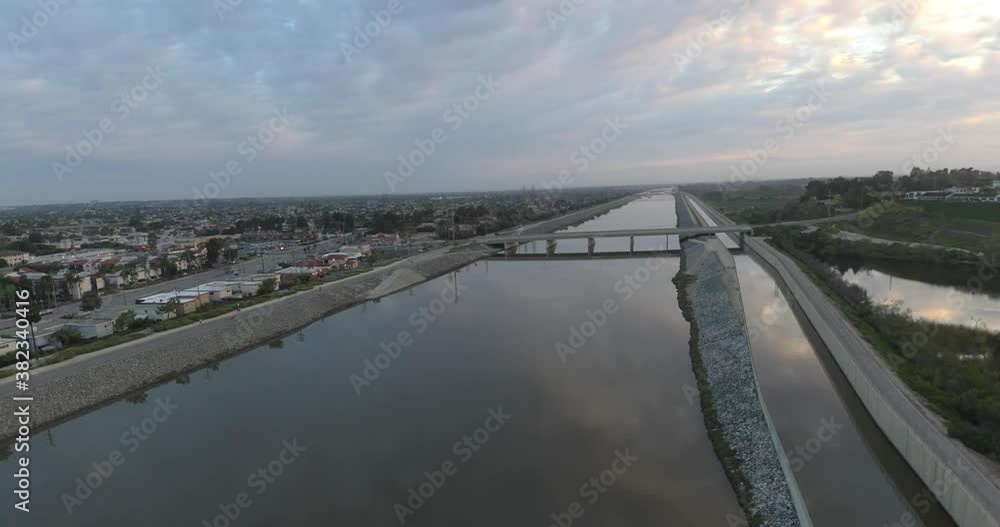 An amazing 4K UHD parallax aerial view gliding over the water in an urban area at sunrise. An amazing 4K UHD parallax aerial view gliding over the water in an urban area at sunrise.