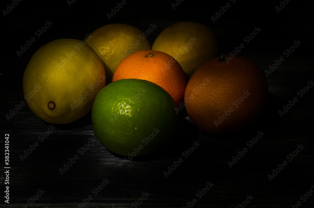 Still life with lime and lemons on the wooden background Still life with lime and lemons on the wooden background