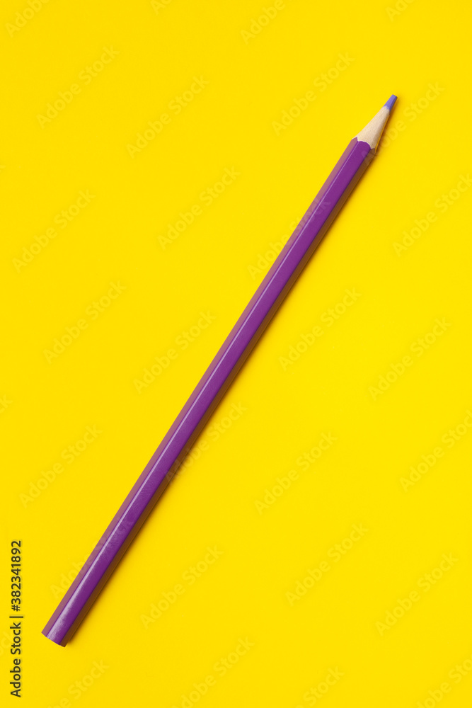 diagonal purple sharp wooden pencil on a bright yellow background, isolated, copy space, mock up. diagonal purple sharp wooden pencil on a bright yellow background, isolated, copy space, mock up.