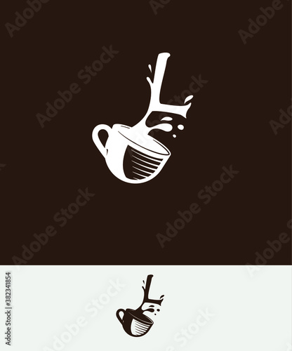 a cup of coffee with the letter L spilled