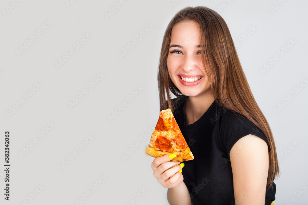 Pizza in the hands of a girl with a smile, with copy space. Concept photo for pizzerias. Pizza in the hands of a girl with a smile, with copy space. Concept photo for pizzerias.
