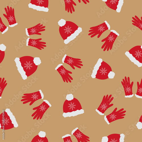 Bright red hats and gloves with white fur on beige background. Seamless doodle cozy  winter clothes pattern. Suitable for textile, wrapping, wallpaper.