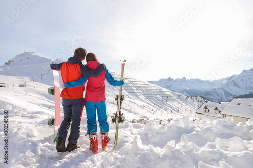 Man and woman enjoying a day skiing in the mountain