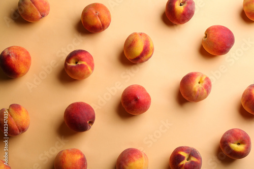 Fresh ripe peaches on beige background, flat lay