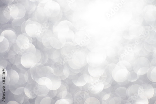 Silver white glittering Christmas lights. Blurred abstract background