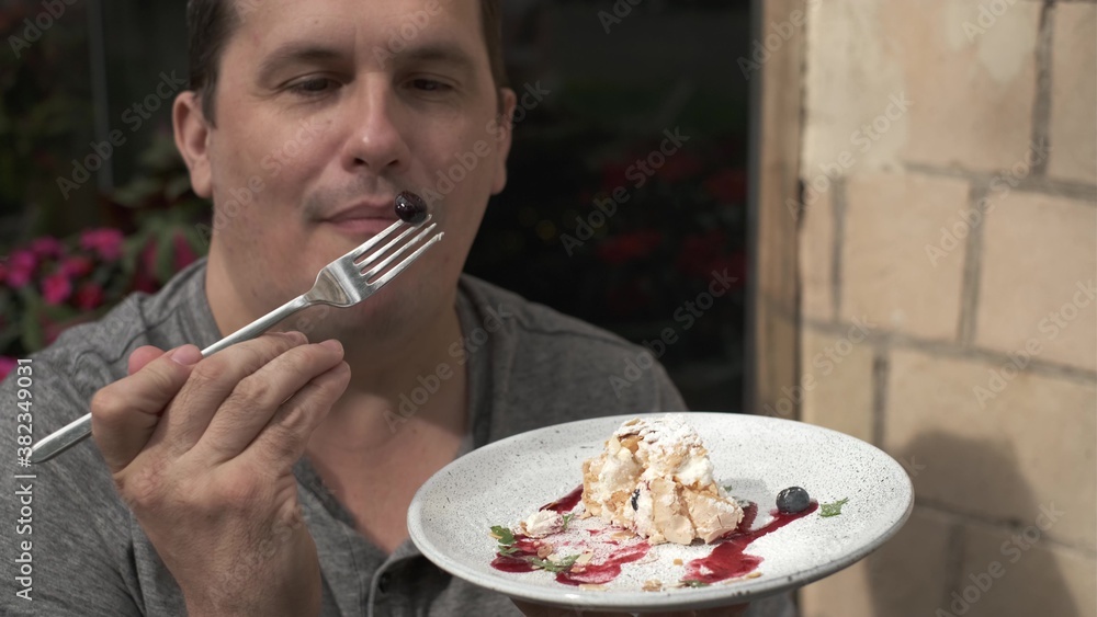 Man eating meringue roll