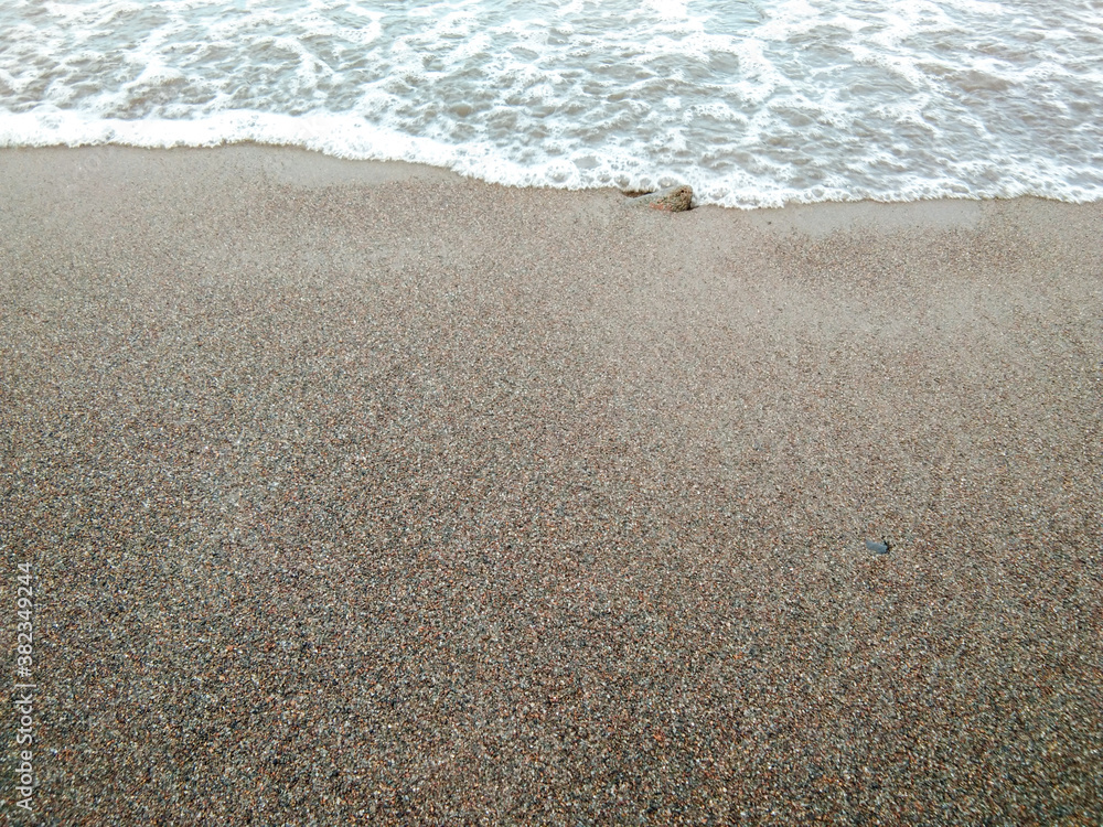 waves on the beach with black sands. waves on the beach with black sands.