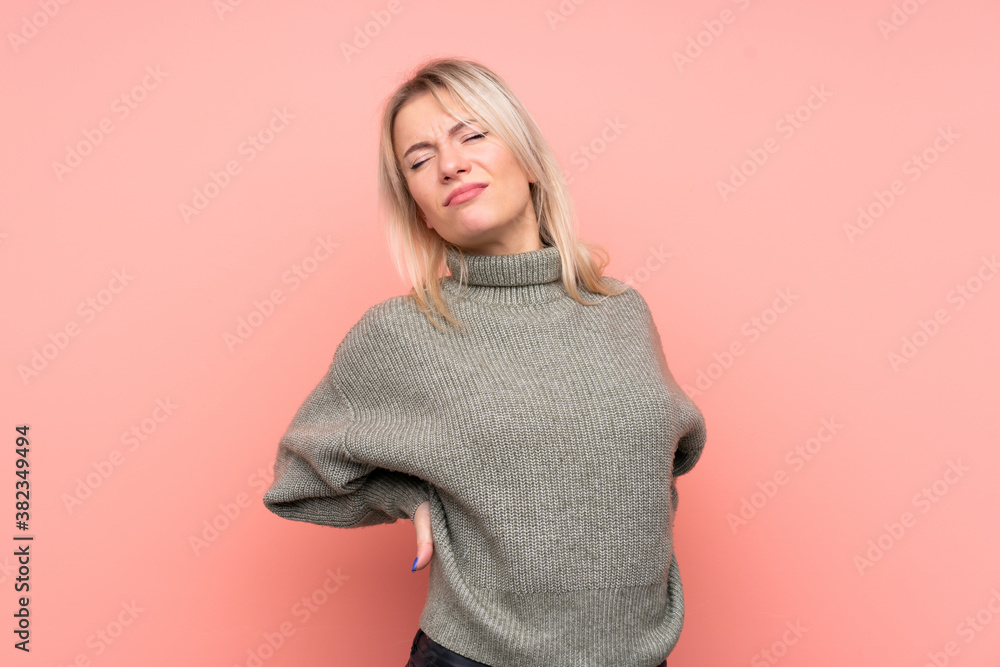 Young blonde Russian woman over isolated pink background suffering from backache for having made an effort Young blonde Russian woman over isolated pink background suffering from backache for having made an effort