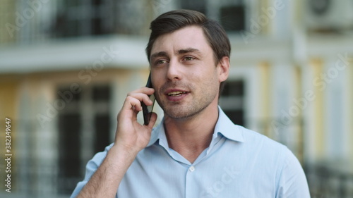 Close up businessman talking phone. Man talking phone in shirt outdoors