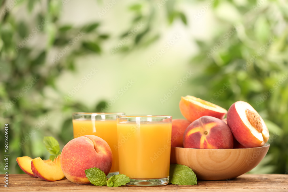 Natural peach juice and fresh fruits on wooden table Natural peach juice and fresh fruits on wooden table