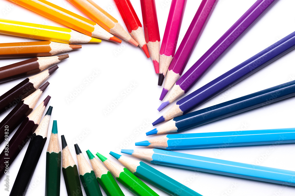 circle or rainbow swirl of colored pencils on a white background on the left, copy space, mock up, LGBT symbol.