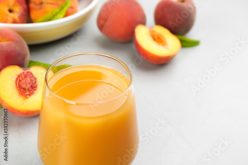 Natural freshly made peach juice on light table, closeup
