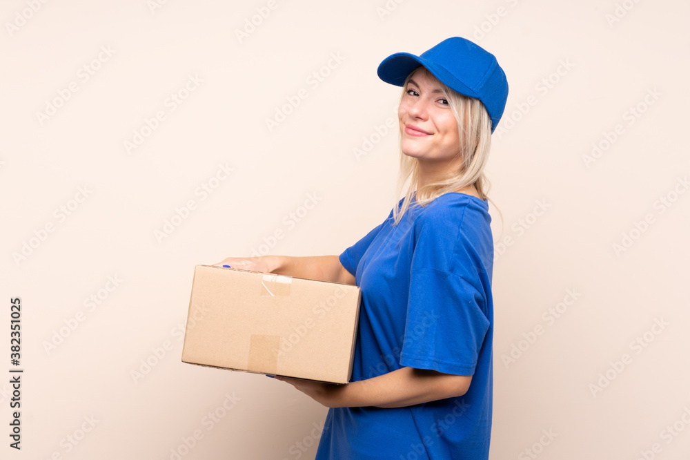 Young delivery woman over isolated background laughing Young delivery woman over isolated background laughing