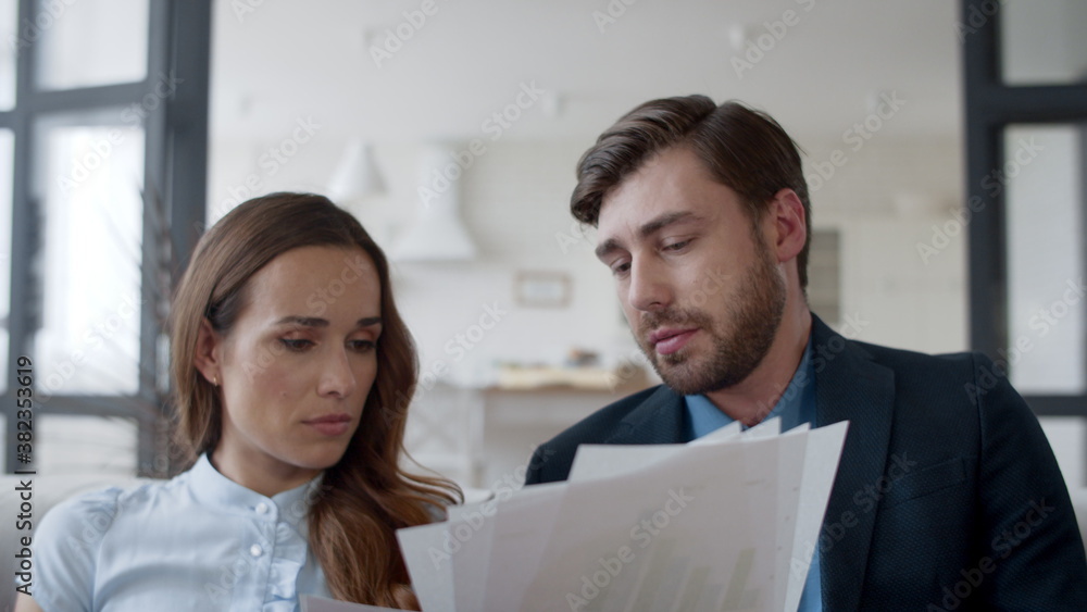 Young couple discussing family business in home office in slow motion. Young couple discussing family business in home office in slow motion.