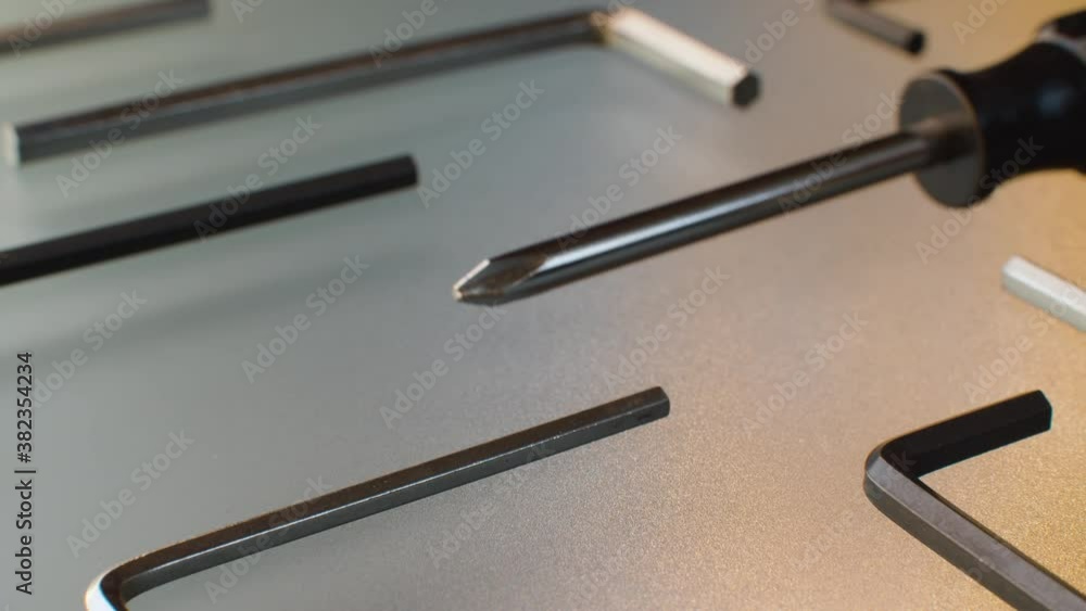 Extreme close up screwdrivers and hex keys on a glass table. Hex and phillips screwdrivers. Camera slowly moving on slider, dolly shot, macro plan. Extreme close up screwdrivers and hex keys on a glass table. Hex and phillips screwdrivers. Camera slowly moving on slider, dolly shot, macro plan.