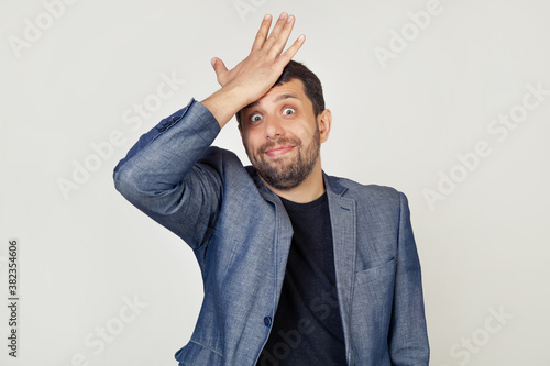 Canvastavla Young businessman man with a beard in a jacket, with an expression of frustration and misunderstanding