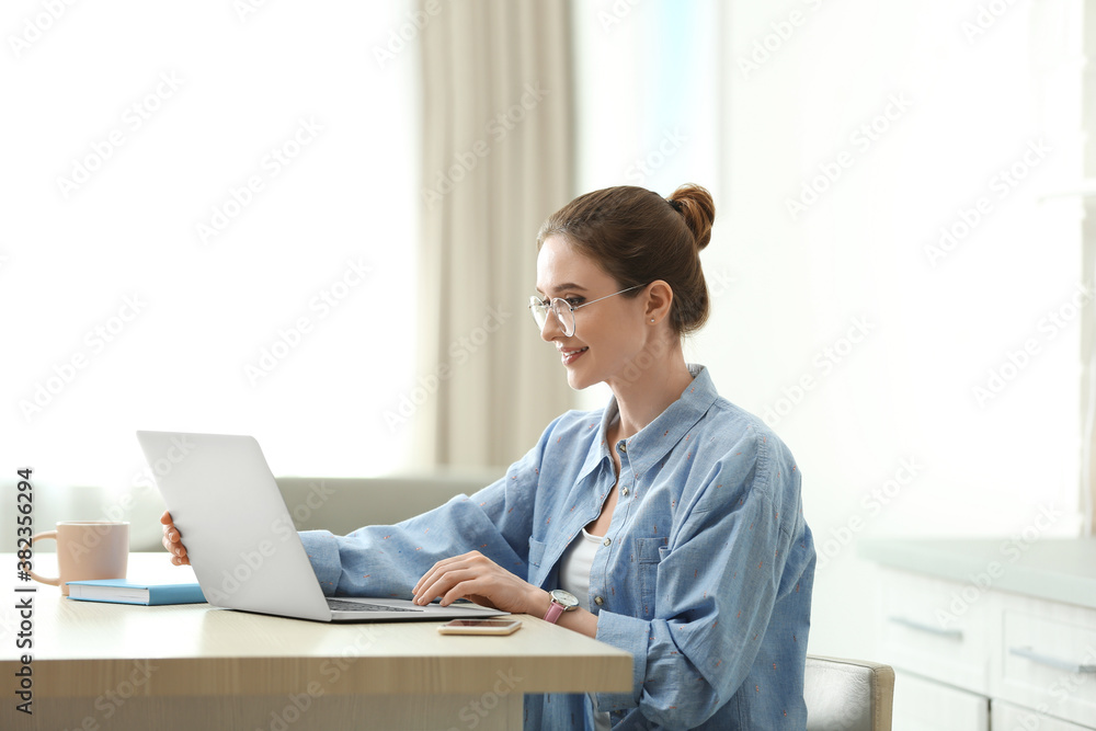 Young woman working on laptop at home Young woman working on laptop at home