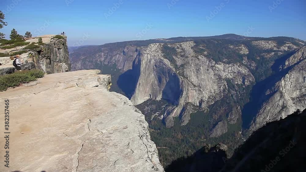 Photographer woman at panorama of Taft Point in Yosemite National Park, California, United States. The view from Taft Point: Half Dome, Liberty Cap, Yosemite Valley and Nevada Fall. Photographer woman at panorama of Taft Point in Yosemite National Park, California, United States. The view from Taft Point: Half Dome, Liberty Cap, Yosemite Valley and Nevada Fall.