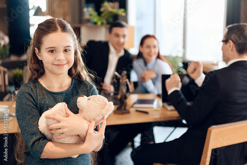 Happy little girl is hugging teddy bear. 