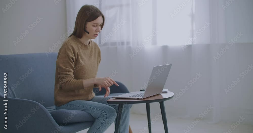 woman is communicating online, using laptop with internet and headphones with microphone, online chat, tech support woman is communicating online, using laptop with internet and headphones with microphone, online chat, tech support