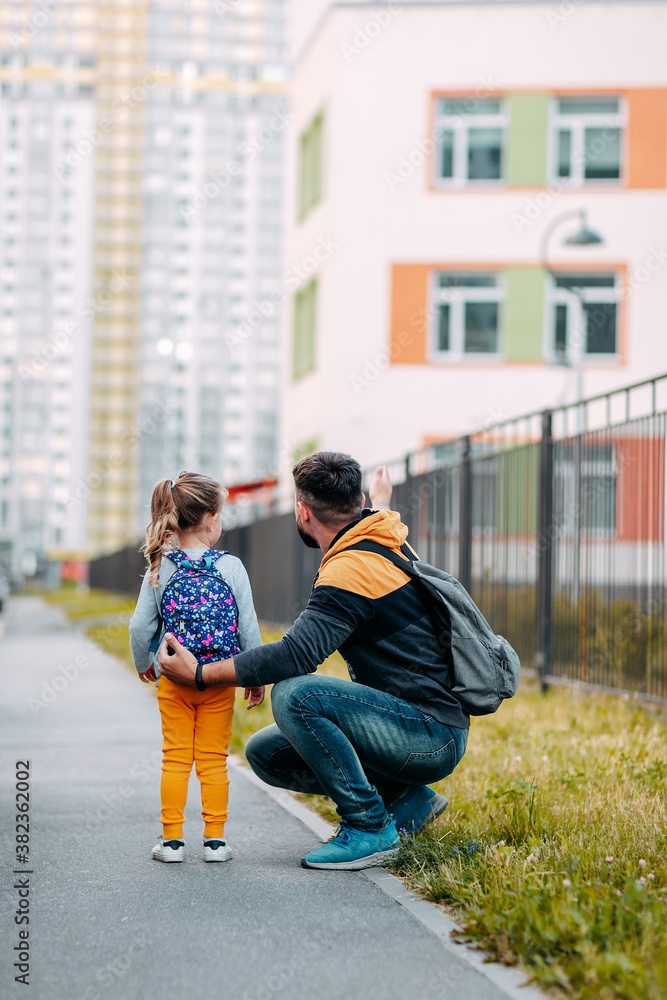 Father and daughter going to school for the first time. Back to school after pandemic.