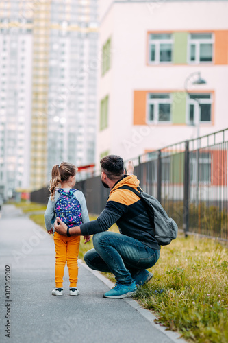 Obraz na płótnie Father and daughter going to school for the first time. Back to school after pandemic. w salonie