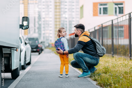Father and daughter going to school for the first time. Back to school after pandemic.
