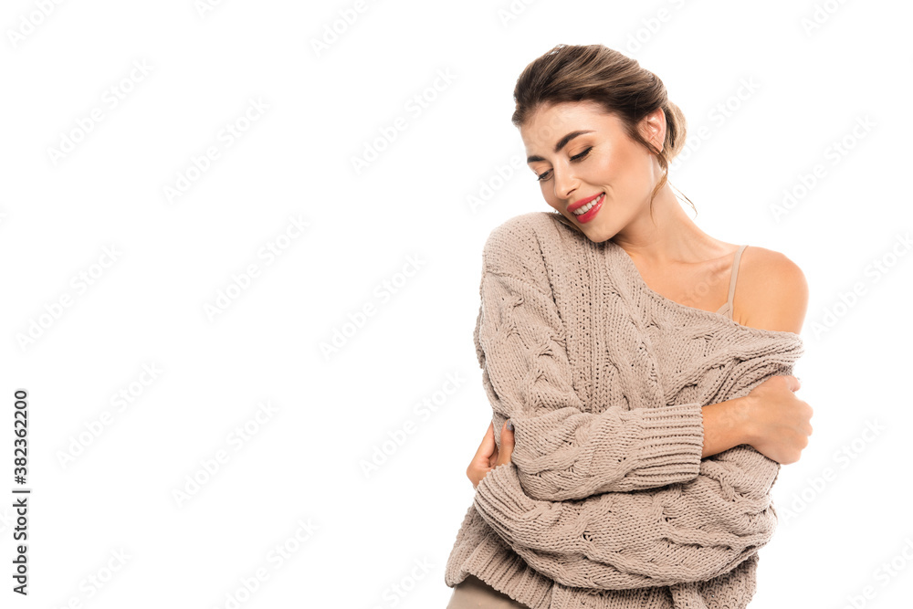 joyful woman in openwork sweater hugging herself with closed eyes isolated on white joyful woman in openwork sweater hugging herself with closed eyes isolated on white