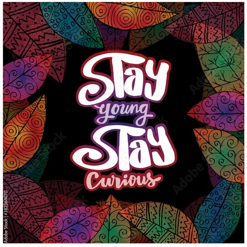 Stay young stay curious hand lettering. Quote typography. Leafs background.