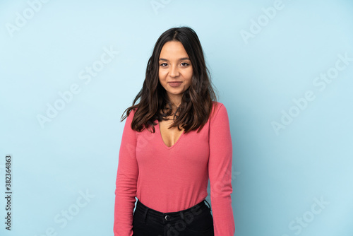 Young mixed race woman isolated on blue background laughing