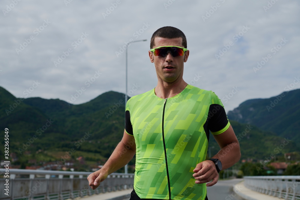 triathlon athlete running on street triathlon athlete running on street