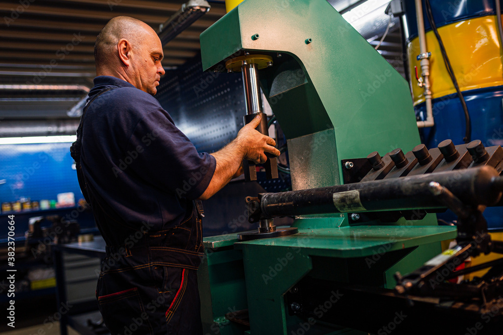 Male engineer metalworker industrial experienced operator technician worker working on machine with metal, professional man in industry technology manufacturing factory workshop, artistic noise Male engineer metalworker industrial experienced operator technician worker working on machine with metal, professional man in industry technology manufacturing factory workshop, artistic noise