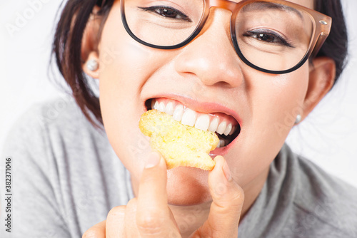 Close-up pictures of an Asian woman enjoying her eating.