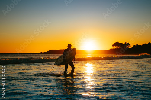 Surfing at sunset on the Ocean in Spain