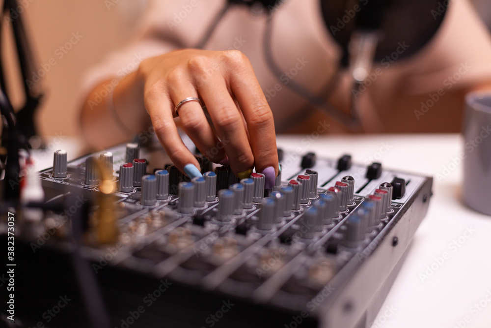 Content creator checking sound on dj mixer for better podcast. Creative online show presenter, On-air online production internet broadcast show host streaming live content, recording digital media Content creator checking sound on dj mixer for better podcast. Creative online show presenter, On-air online production internet broadcast show host streaming live content, recording digital media