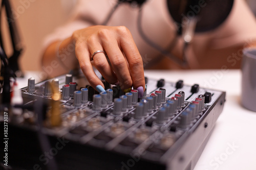Content creator checking sound on dj mixer for better podcast. Creative online show presenter, On-air online production internet broadcast show host streaming live content, recording digital media