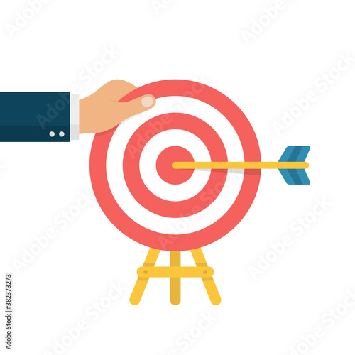 Goal Setting Concept. Hand Holding Bullseye After Hitting by Arrow. Goal Achievement.