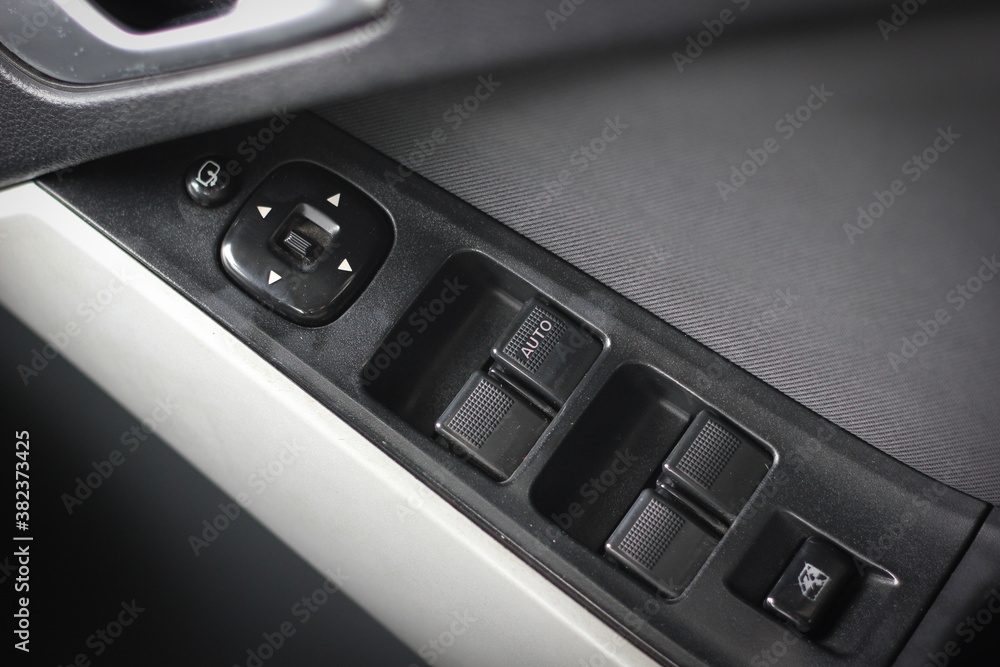 Car arm rest with Control Panel. Door Lock & Mirror Control. window adjustment buttons, door lock. Photography of a modern car. Car arm rest with Control Panel. Door Lock & Mirror Control. window adjustment buttons, door lock. Photography of a modern car.