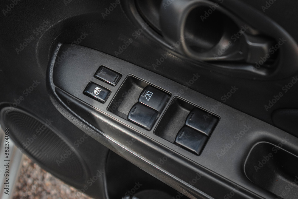 Car arm rest with Control Panel. Door Lock & Mirror Control. window adjustment buttons, door lock. Photography of a modern car.