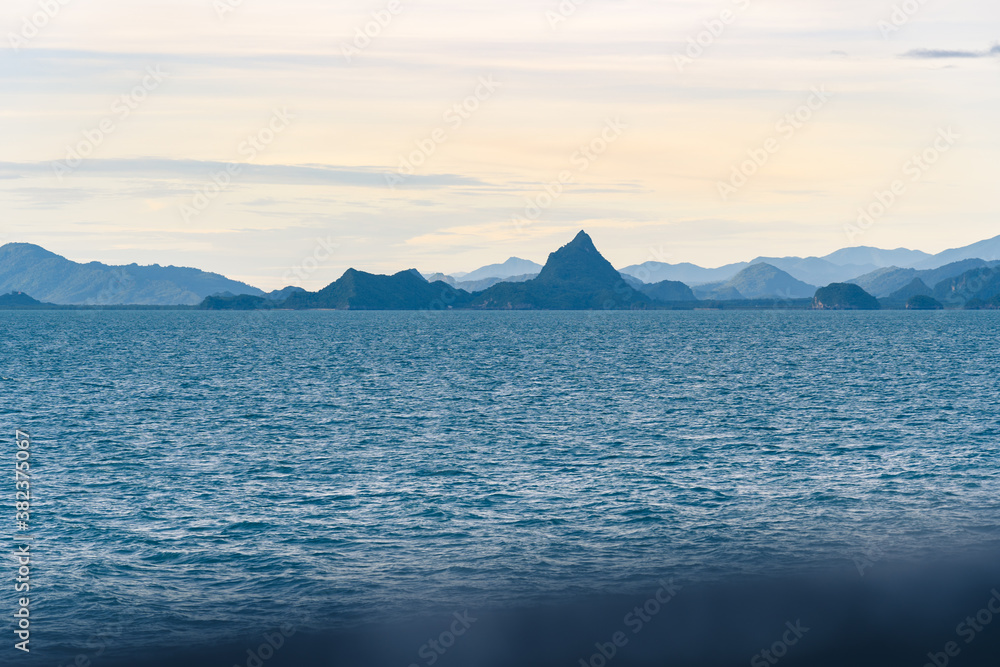 Panorama of the sea lagoon with islands and mountains at sunrise. View from ferry boat.