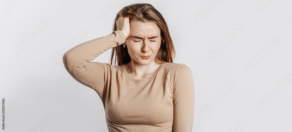 Beautiful young girl posing looking at the camera on a white isolated background. Serious brunette woman ignores covers her ears with her hands and closes her eyes, does not see and does not hear Beautiful young girl posing looking at the camera on a white isolated background. Serious brunette woman ignores covers her ears with her hands and closes her eyes, does not see and does not hear