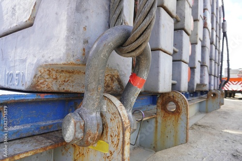 Shackles and wire slings set connecting to lift up counterweight of crawler crane at the construction area in heavy duty industrial or oil and gas plant.