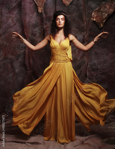 brunette woman wearing yellow evening dress