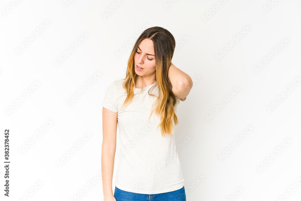 Young caucasian woman isolated on white background having a neck pain due to stress, massaging and touching it with hand. Young caucasian woman isolated on white background having a neck pain due to stress, massaging and touching it with hand.