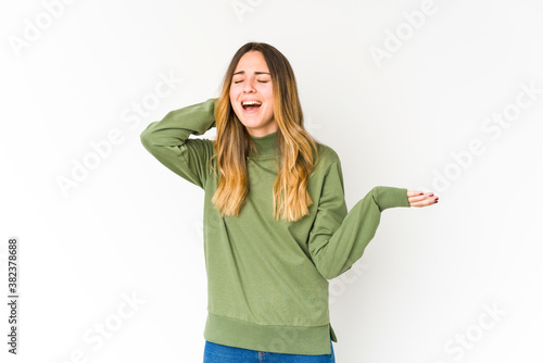 Young caucasian woman isolated on white background screaming with rage.