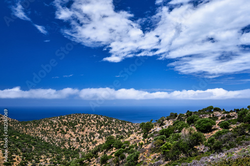Typical Greek or Cretan landscape, hills and mountains, spring foliage, bush, olive tree, rocky road, path. Akrotiri peninsula, Chania, Crete, Greece