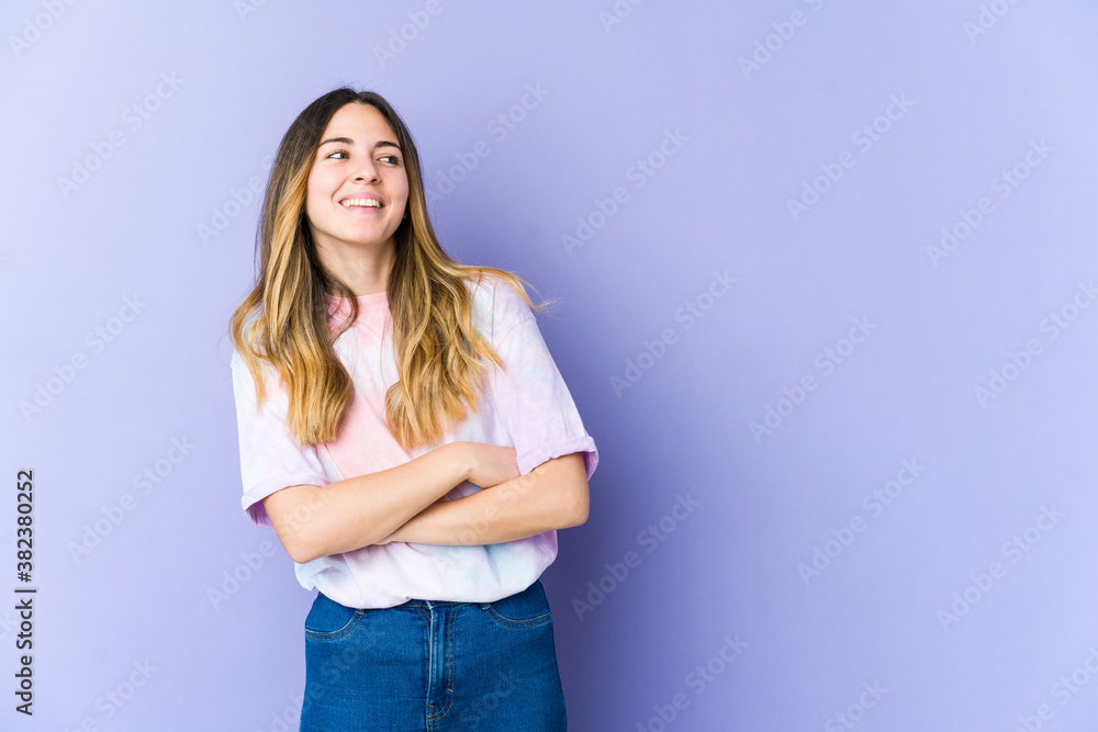Young caucasian woman isolated on purple background smiling confident with crossed arms. Young caucasian woman isolated on purple background smiling confident with crossed arms.