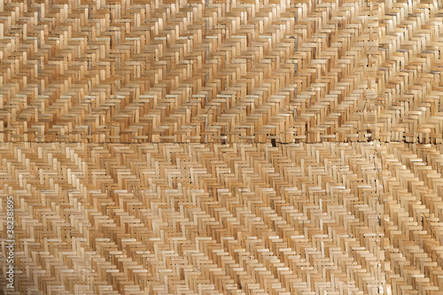 Handcraft woven bamboo brown straw mat abstract background texture.