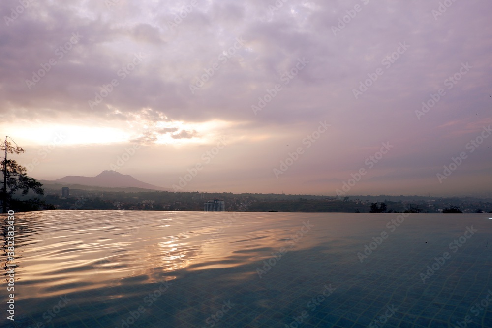 Sunrise at East Java, Indonesia, reflect beautiful mountain view at infinity swimming pool